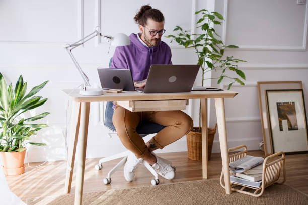 istock Man working on computer and digital tablet in his home office during pandemic 1314630402
