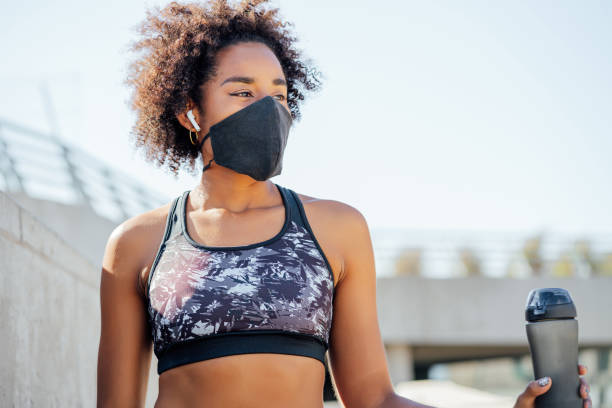 istock Athletic woman drinking water after work out outdoors. 1314631293