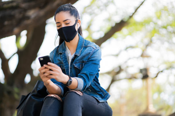 istock Young woman using her mobile phone outdoors. 1314631316