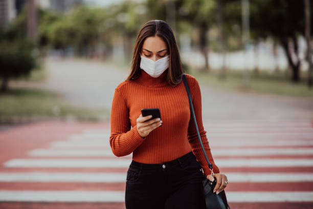 istock Woman walking on the street with protective mask 1314634237
