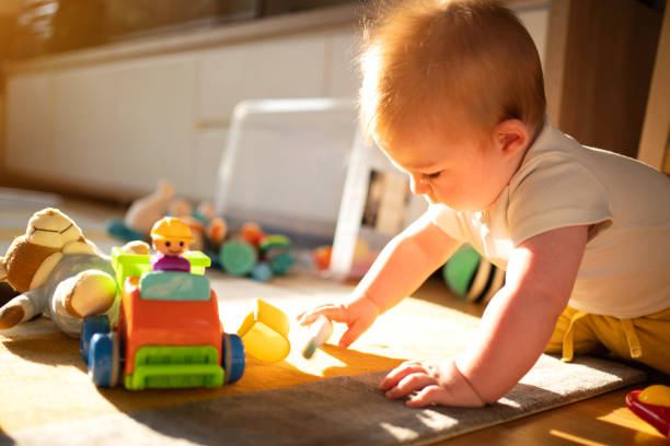 istock Curious baby boy playing with his toys 1314635626