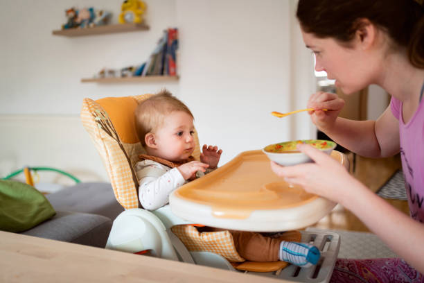 istock Mother feeding her baby boy at home 1314636528