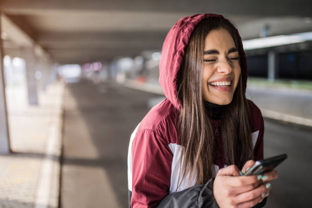 istock Cute sporty young woman using phone and laughing. 1314638217