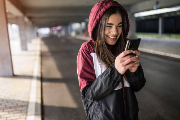 istock Cute sporty young woman using phone and laughing. 1314638270