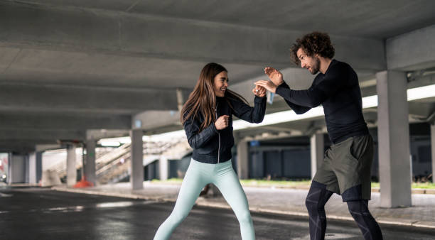 Young athletic couple practicing boxing skills.