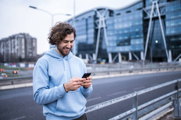 istock Young sportsman using phone outdoors. 1314639851