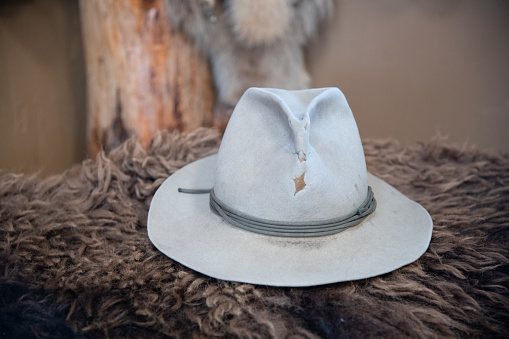 Old western hat laying on buffalo hide in Montana, western USA.