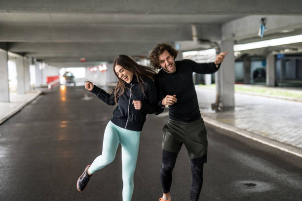 istock Playful young athletic couple having fun outdoors. 1314640122