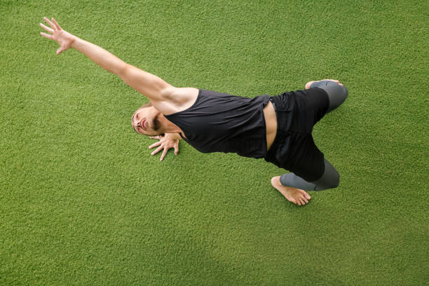istock sportsman training at gym stretching on the floor 1314642985