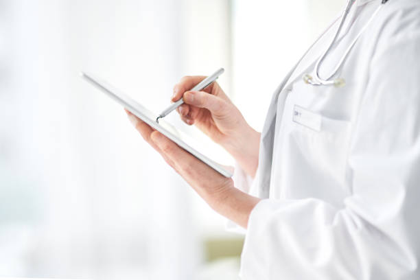 istock Cropped shot of an unrecognizable female doctor using her tablet while standing in the hospital 1314644893