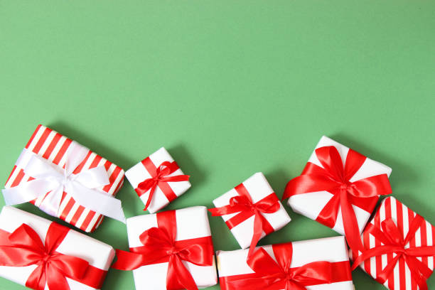istock Set of beautifully wrapped gift boxes on a colored background top view. 1314647902