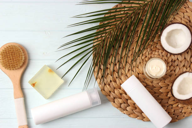 istock Cosmetic jars and coconut on the table close-up and place for text. 1314651523