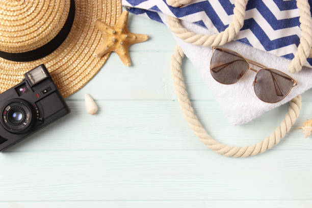istock travel accessories and tropical leaves on a colored background top view. 1314653399