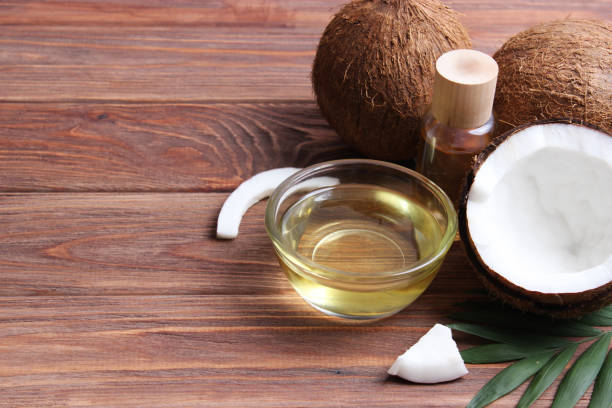 istock coconut oil and coconuts, palm branches close up 1314655184