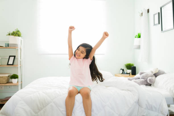 istock Happy kid feeling well rested in her comfy bed 1314659338