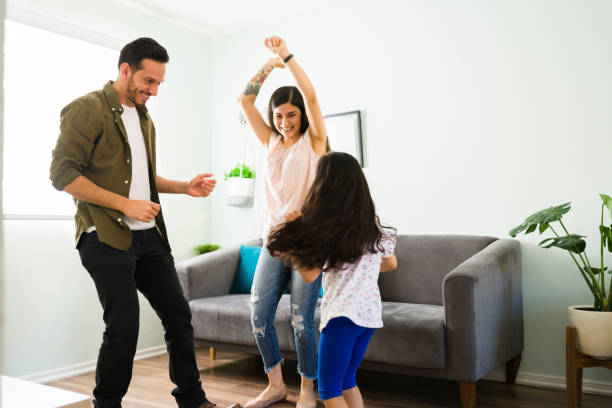 istock Parents and daughter having fun at home 1314659487