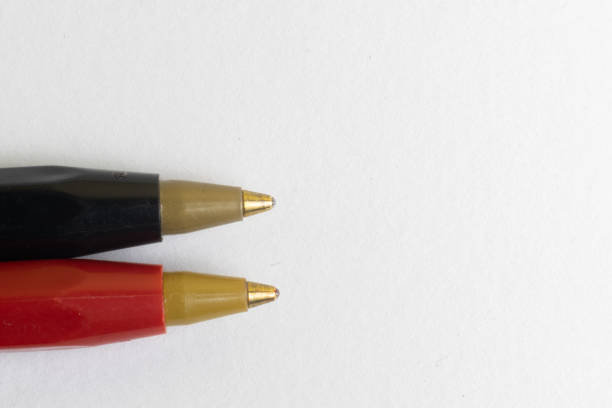 istock One black and one red pen on a white background 1314659571