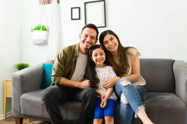 Loving parents and kid smiling at the camera