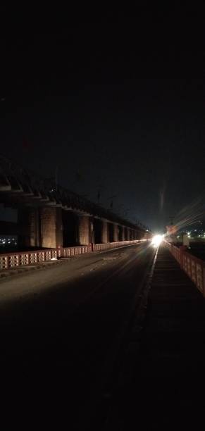 istock Bridge Night time bike headlight shines. 1314661493