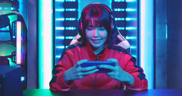 cyber sport gamer win game Young Asian Pretty Pro Gamer win in Online Video Game and cheer with hand up gamer stock pictures, royalty-free photos & images