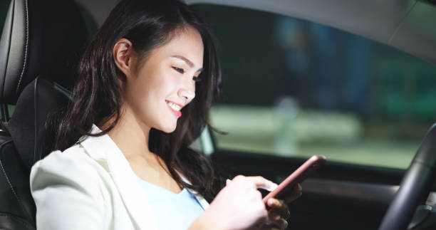 istock businesswoman use phone in car 1314664536