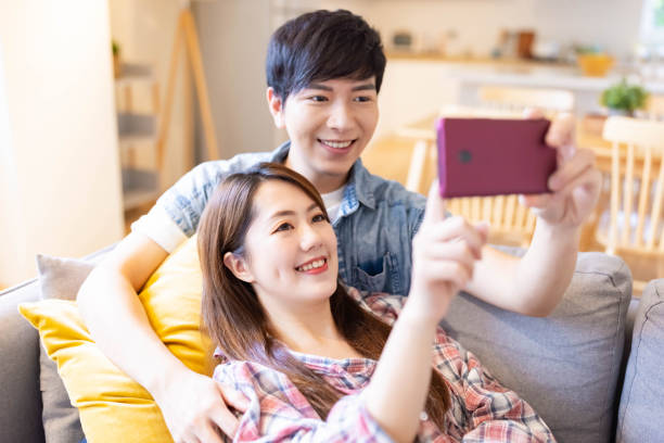 istock couple watch video on mobile 1314665457