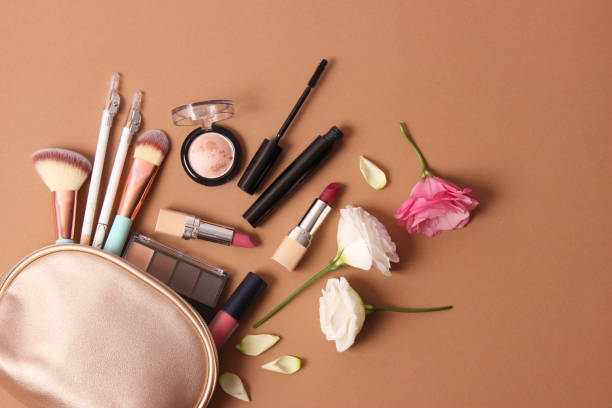 istock cosmetics and flowers on a colored background top view. 1314666159