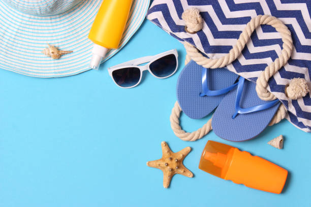 istock travel accessories and tropical leaves on a colored background top view. 1314674973