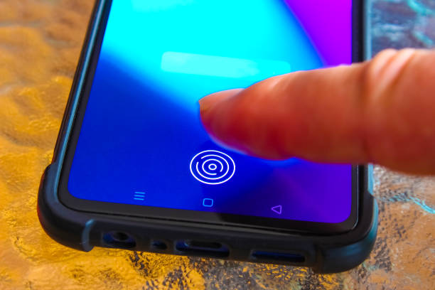 istock Hand holding modern mobile phone showing application with process of scanning fingerprint on a screen. 1314675140