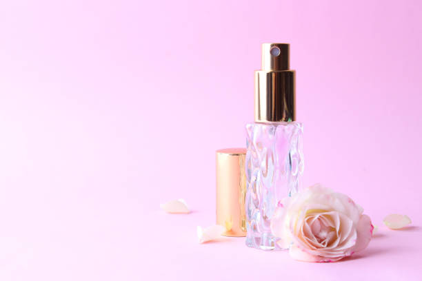 istock Perfume bottle and rose flowers on a light background close up 1314676161