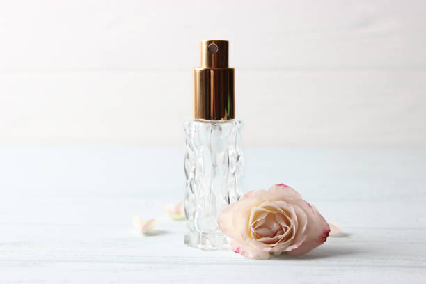 istock Perfume bottle and rose flowers on a light background close up 1314677891