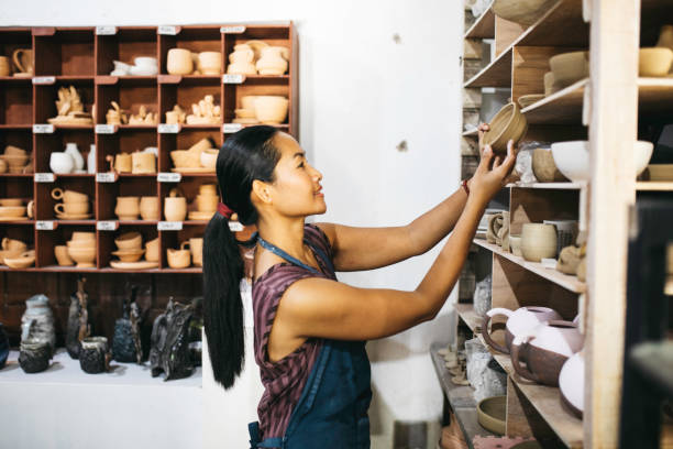 istock Beautiful Young Lady Making Ceramics At Her Workshop 1314679655
