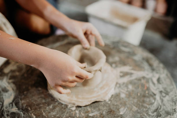 istock Hands of kids enjoying pottery 1314680483