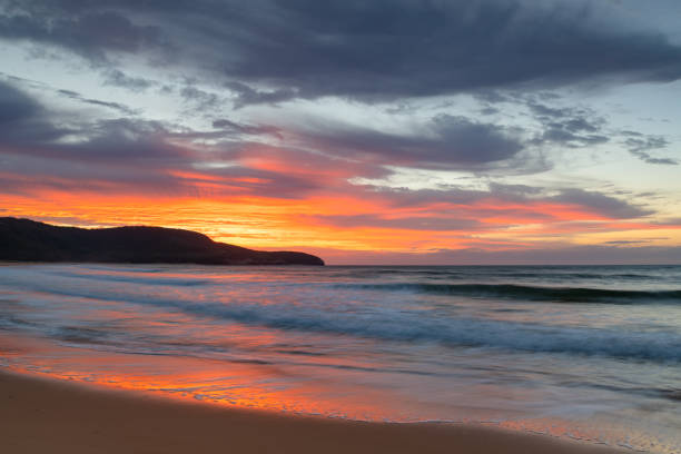 istock Sunrise at the seaside with pastel coloured clouds 1314686551