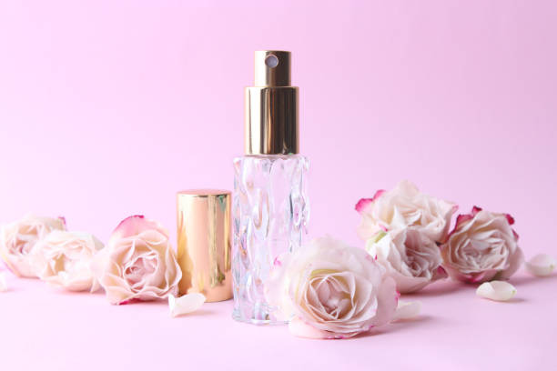 istock Perfume bottle and rose flowers on a light background close up 1314688115