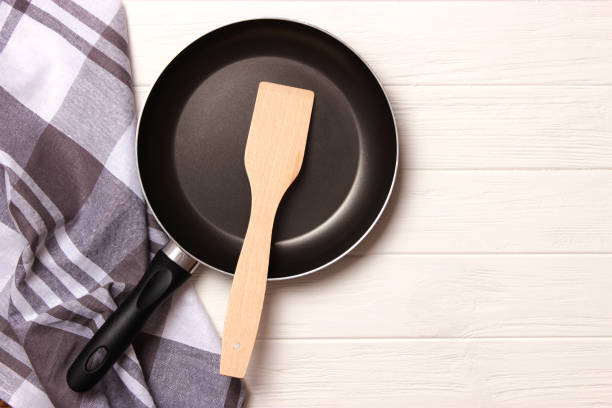 istock frying pan and on the wooden table top view. Cooking. 1314691012