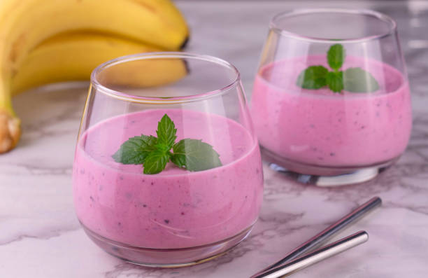 istock Berry smoothie with banana on a marble background. Close-up. 1314691304