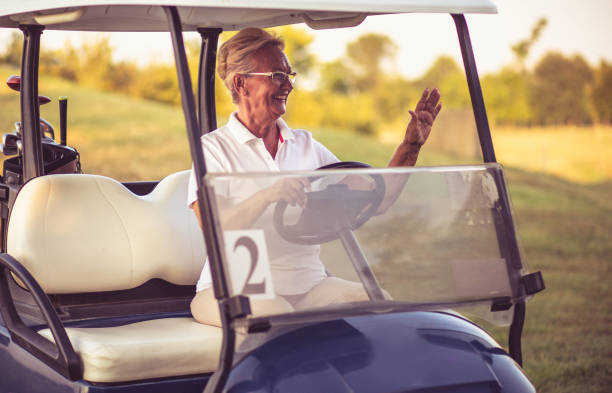 istock Senior woman driving golf car. 1314694136