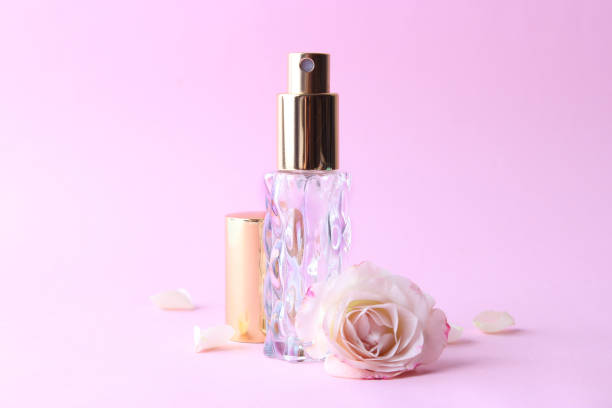 istock Perfume bottle and rose flowers on a light background close up 1314695282