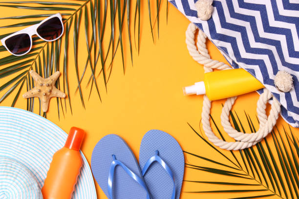 istock travel accessories and tropical leaves on a colored background top view. 1314698681