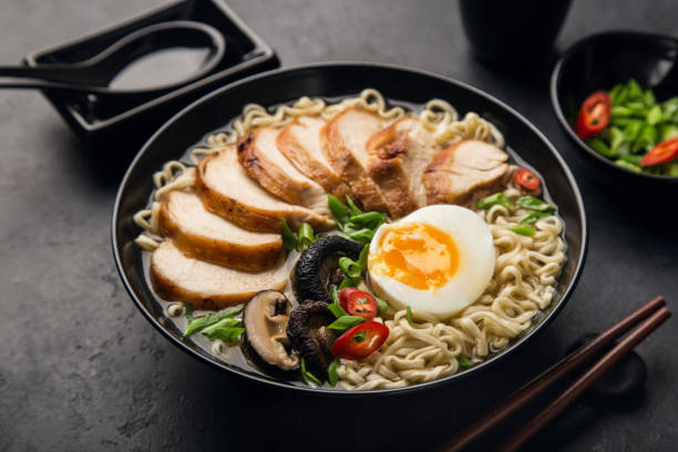 istock japanese ramen noodle with chicken, shiitake mushroms and egg in black bowl, 1314699826