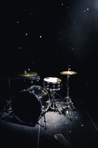 drum set on stage in a concert hall.
