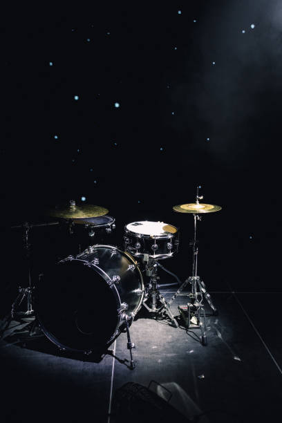drum set on stage in a concert hall drum set on stage in a concert hall. drum percussion instrument photos stock pictures, royalty-free photos & images