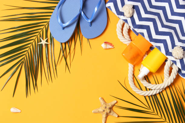 istock travel accessories and tropical leaves on a colored background top view. 1314700931