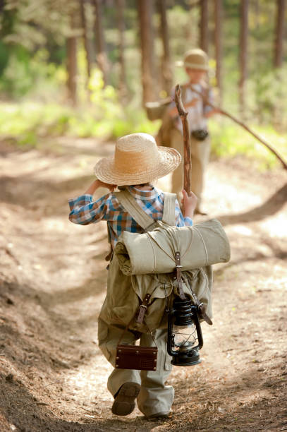 istock Boys on a forest road with backpacks 1314701100