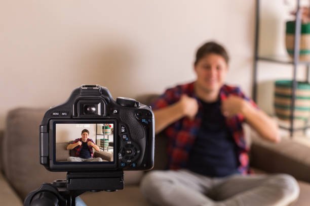 istock Vlogger recording social media video while sitting on the couch 1314704695