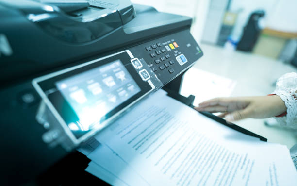 office worker print paper on multifunction laser printer. copy, print, scan, and fax machine in office. modern print technology.  photocopy machine. document and paper work. scanner. secretary work. - print computer printer printout push button imagens e fotografias de stock