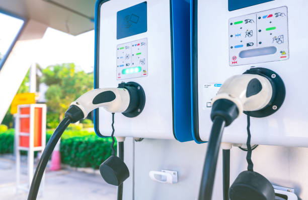 istock Electric car charging station for charge EV battery. Plug for vehicle with electric engine. EV charger. Clean energy. Charging point at car parking lot. Alternative energy. Future transport technology 1314706029