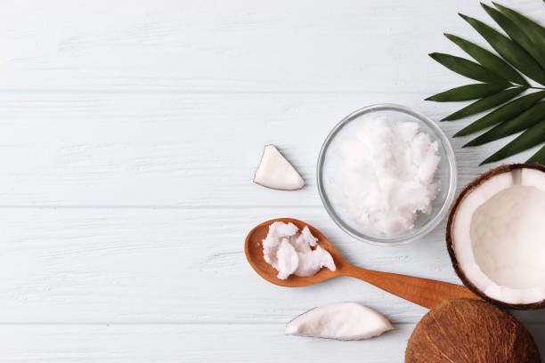 istock coconut oil and coconuts, palm branches close up 1314706335