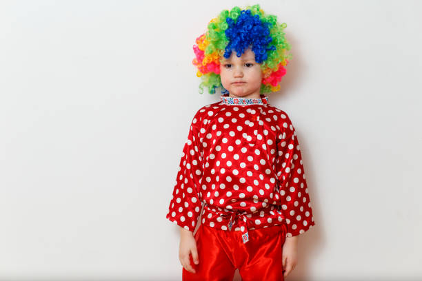istock five-year-old boy in a silk red shirt in peas stands on a white background 1314707367